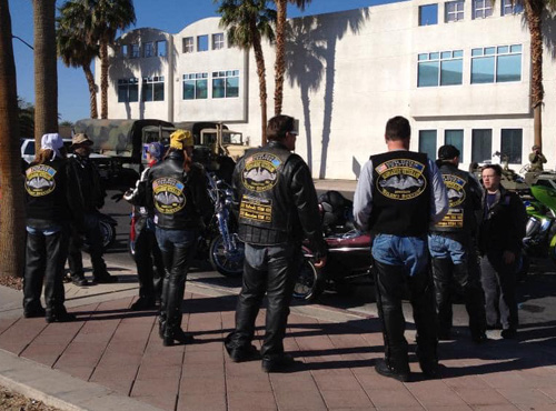 Members walking away showing the back of their vests